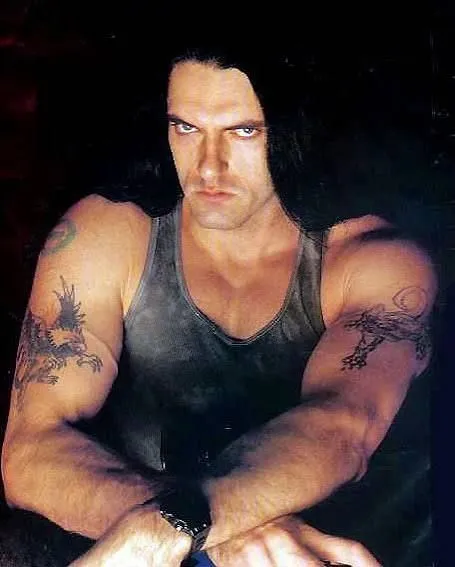 Peter Steele with arms crossed, intense stare, showing his tattoos
